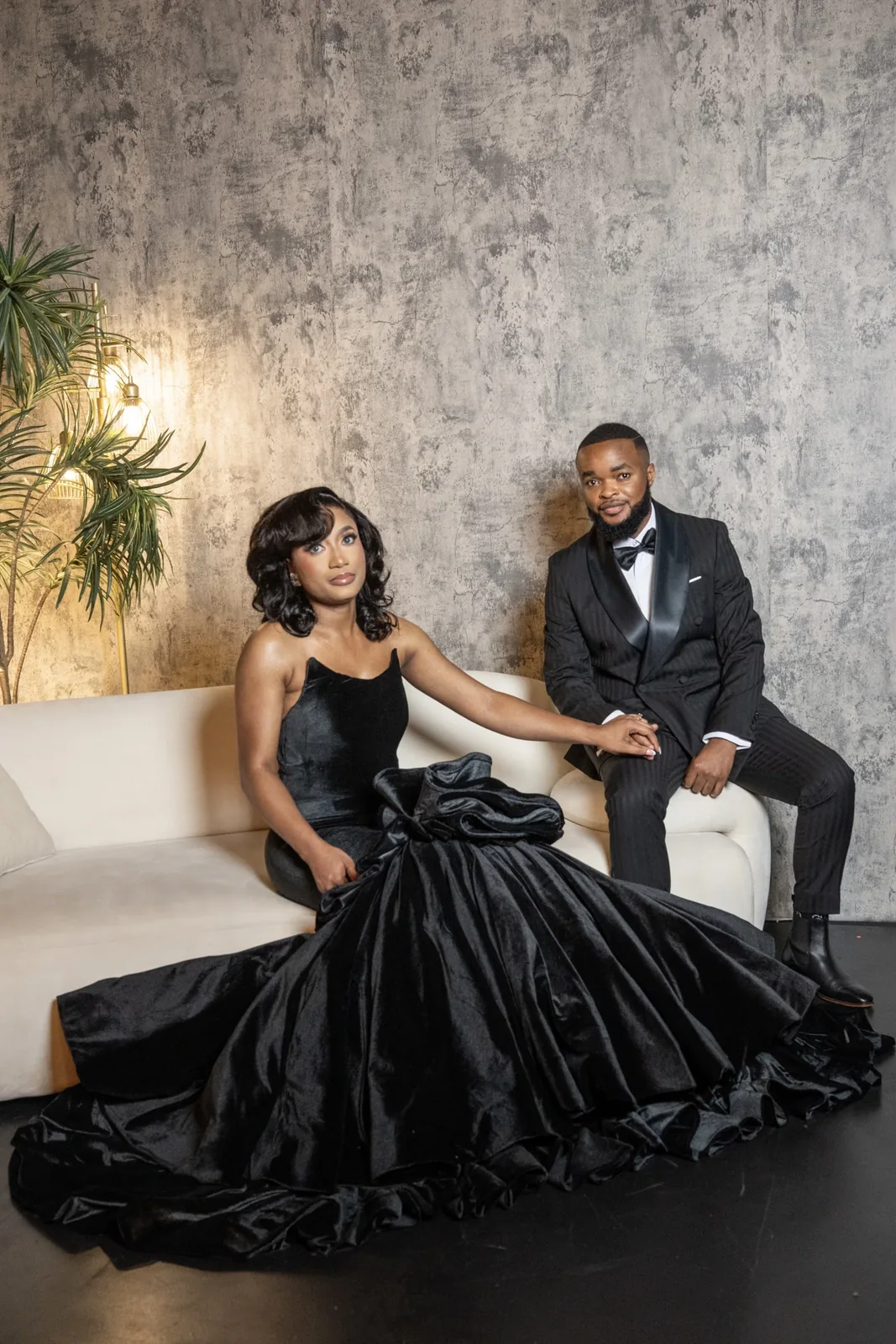 On the ivory sofa — hands, and a gaze held