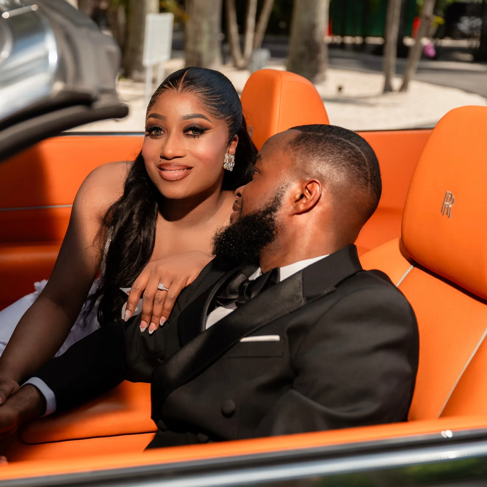 Rear seat — hands held, a quiet knowing